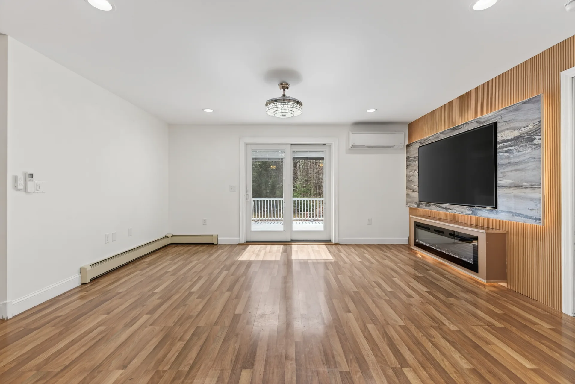 Family room with media wall and linear fireplace