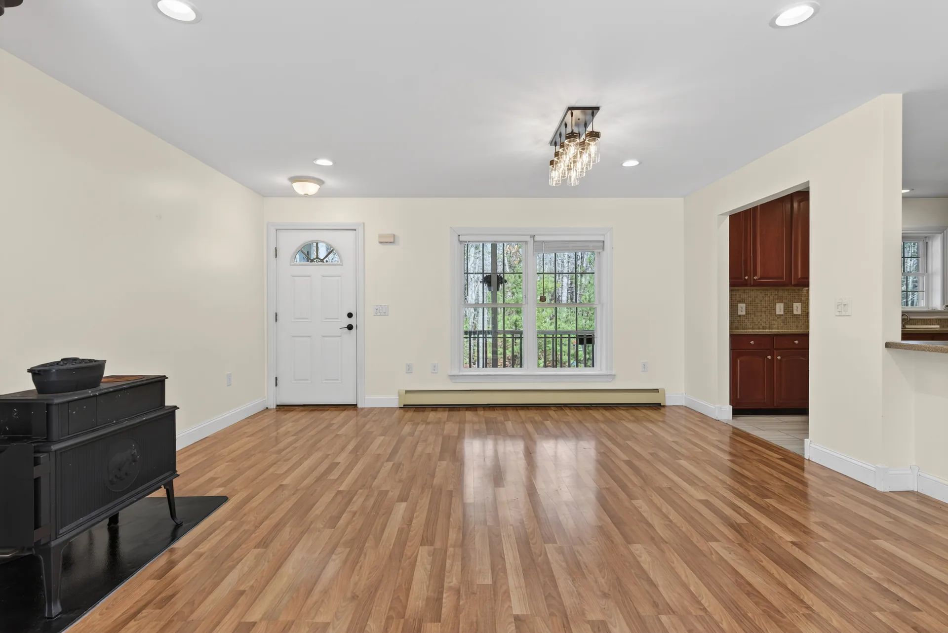 Great room with wood stove and front entry
