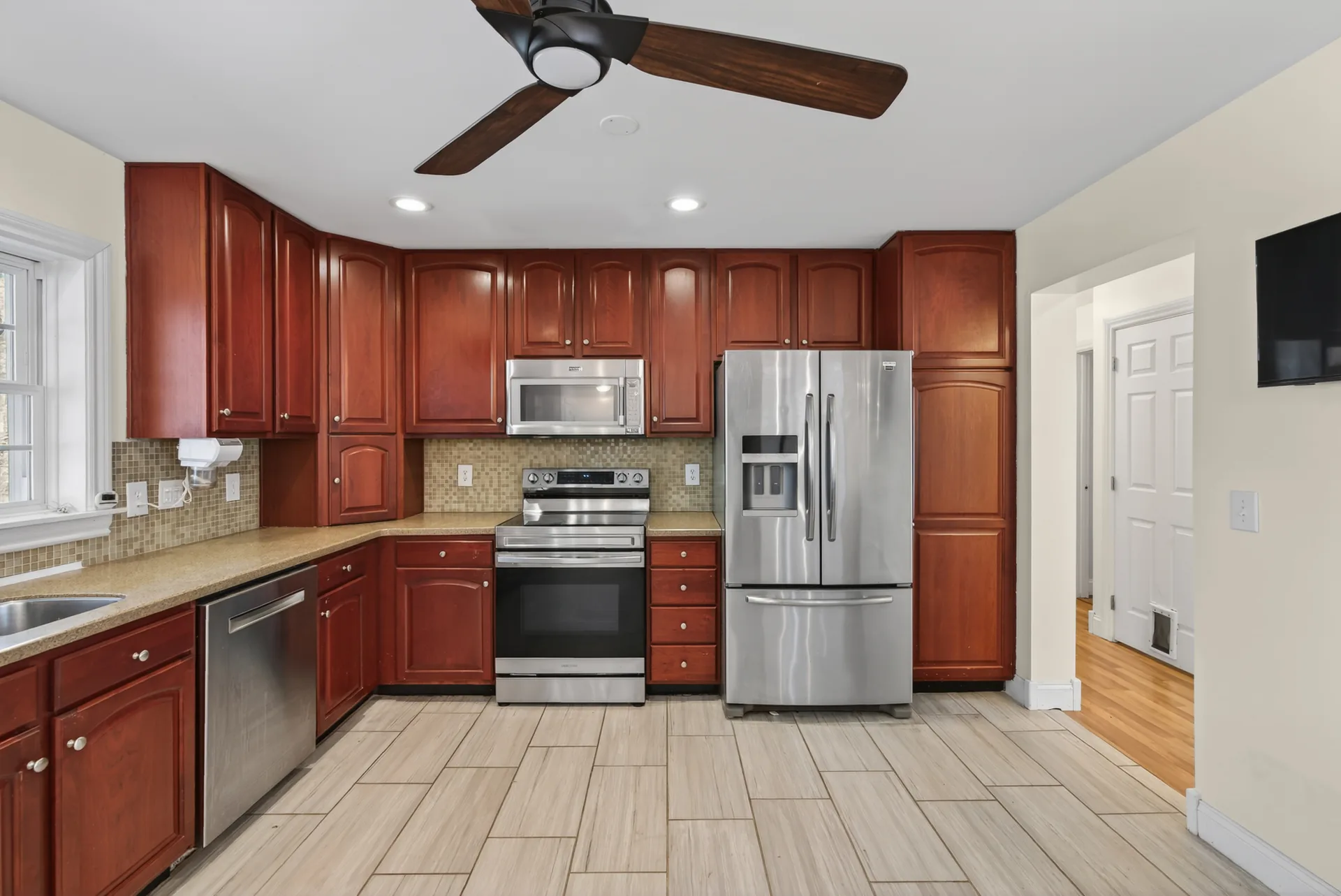 Kitchen cabinetry and ceiling fan