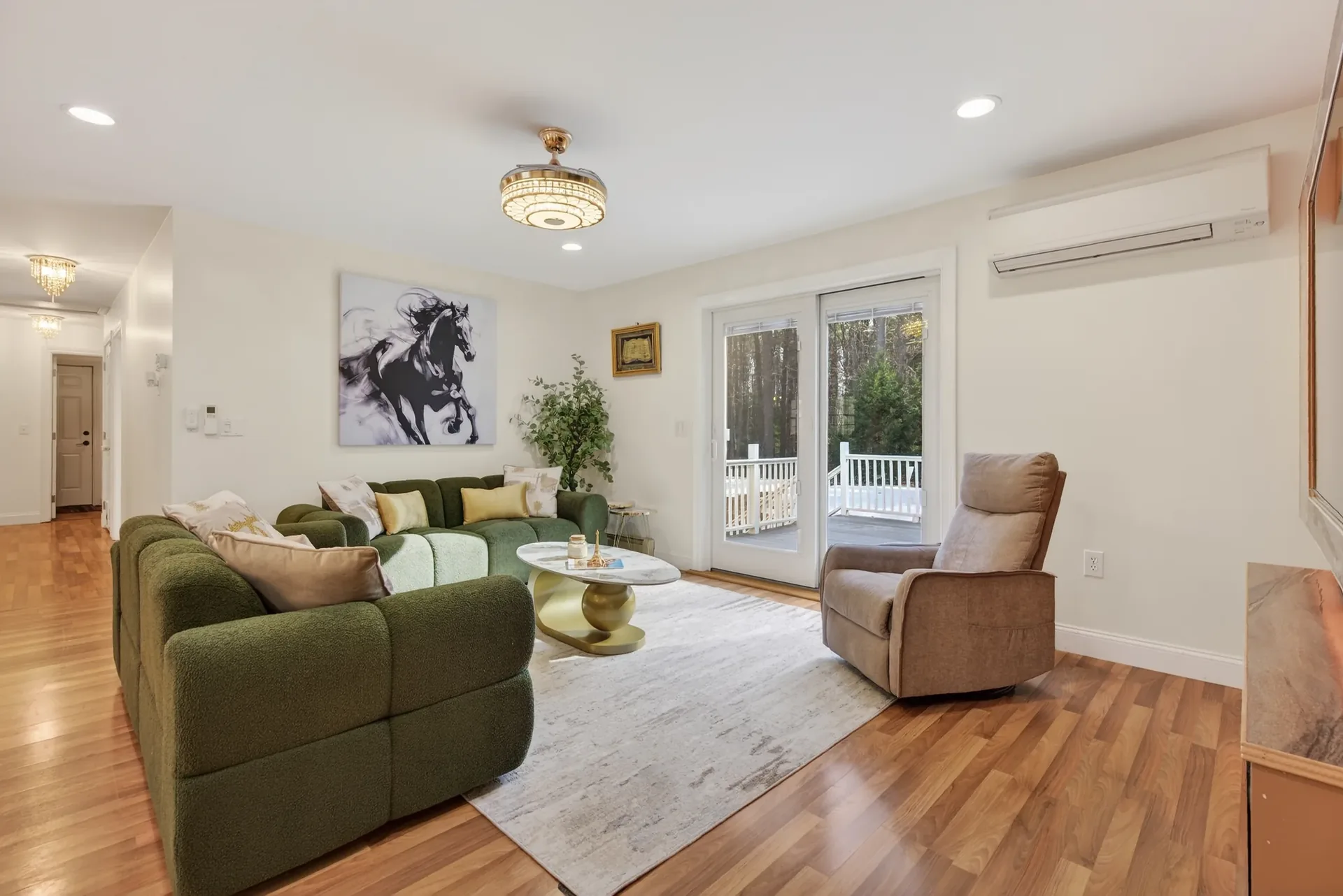 Living room staged — panoramic view to deck